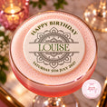 Load image into Gallery viewer, A pink frothy cocktail in a coupe glass with a gold rim, topped with a round white foam insert printed with 'HAPPY BIRTHDAY LOUISE' and a decorative mandala design. The glass is photographed on a softly lit table with candles and flowers in the background.