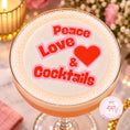 Load image into Gallery viewer, Peace Love & Cocktails edible drink topper on a stylish cocktail glass, perfect for celebrations.