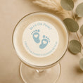 Load image into Gallery viewer, Glass of frothy beverage with a gender reveal cocktail topper with blue feet
