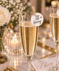 Load image into Gallery viewer, Sip Sip Hooray Edible Cocktail Toppers on a champagne glass with a festive backdrop and celebration elements.