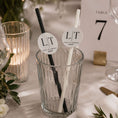 Load image into Gallery viewer, Occasion paper straws personalised initials toppers in a glass with black and white straws for weddings and events.