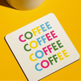 Load image into Gallery viewer, Coffee drink coaster featuring colorful 'COFFEE' text on a bright yellow background.