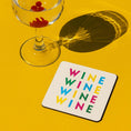 Load image into Gallery viewer, fun wine drink coaster featuring colorful 'WINE' text, perfect for adding fun to your coffee table.