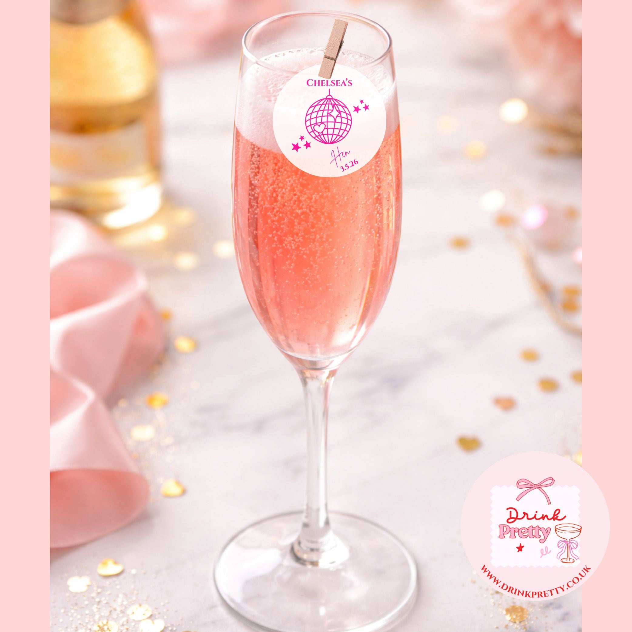 Edible drink toppers for hen parties disco ball on a pink champagne flute at a bridal shower celebration.