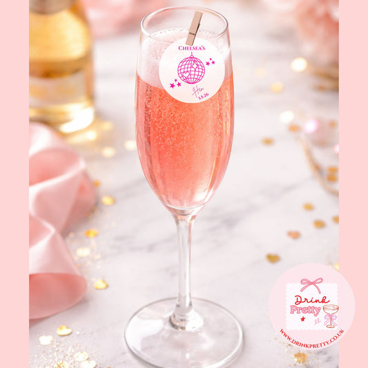 Edible drink toppers for hen parties disco ball on a pink champagne flute at a bridal shower celebration.