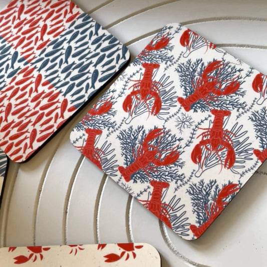 Salty Days - coastal drink coasters set of 4 with vibrant coral and blue designs of shells and lobsters.