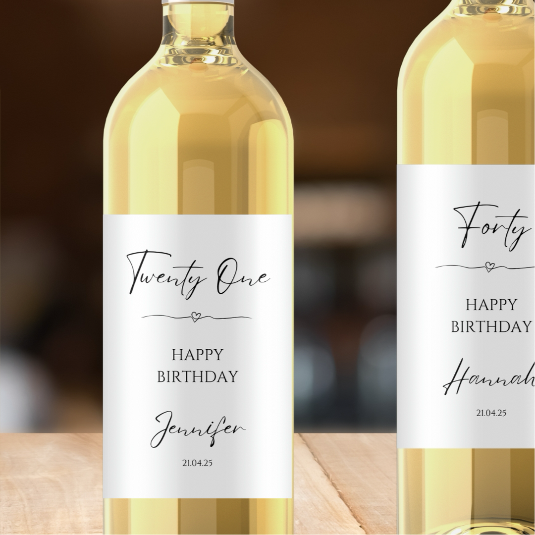 Two wine bottles with personalized labels on a wooden surface.