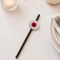 Load image into Gallery viewer, Eyeball Paper Straw Toppers on a black paper straw, perfect for Halloween party decorations.
