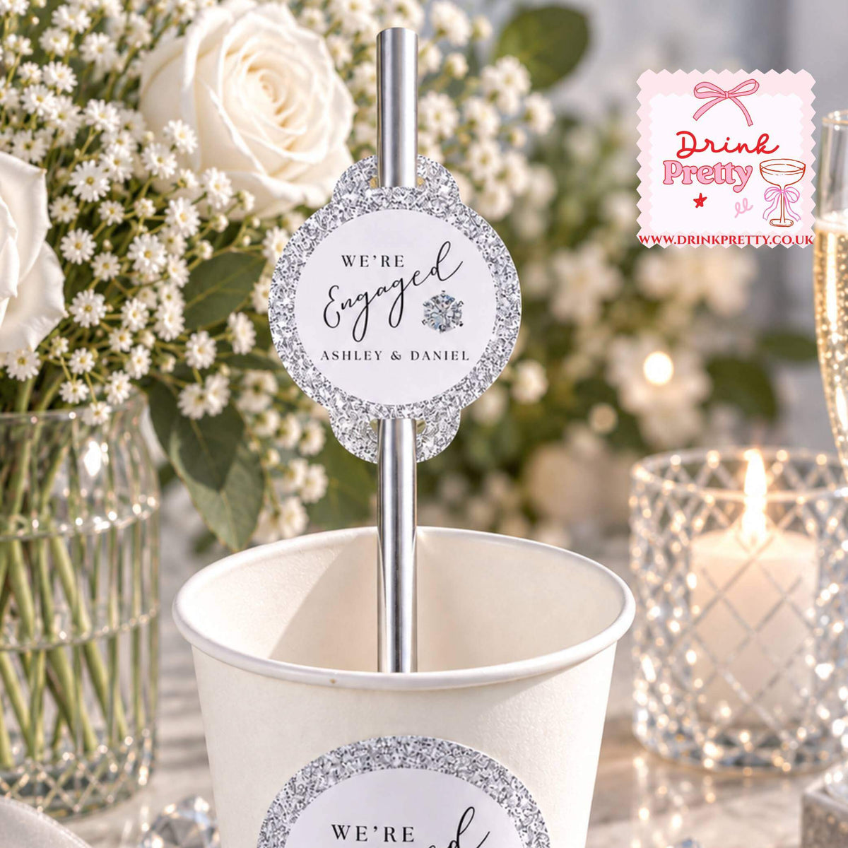 Diamond We're Engaged Paper Straw Toppers in a drink cup with floral decor, perfect for an engagement party celebration.
