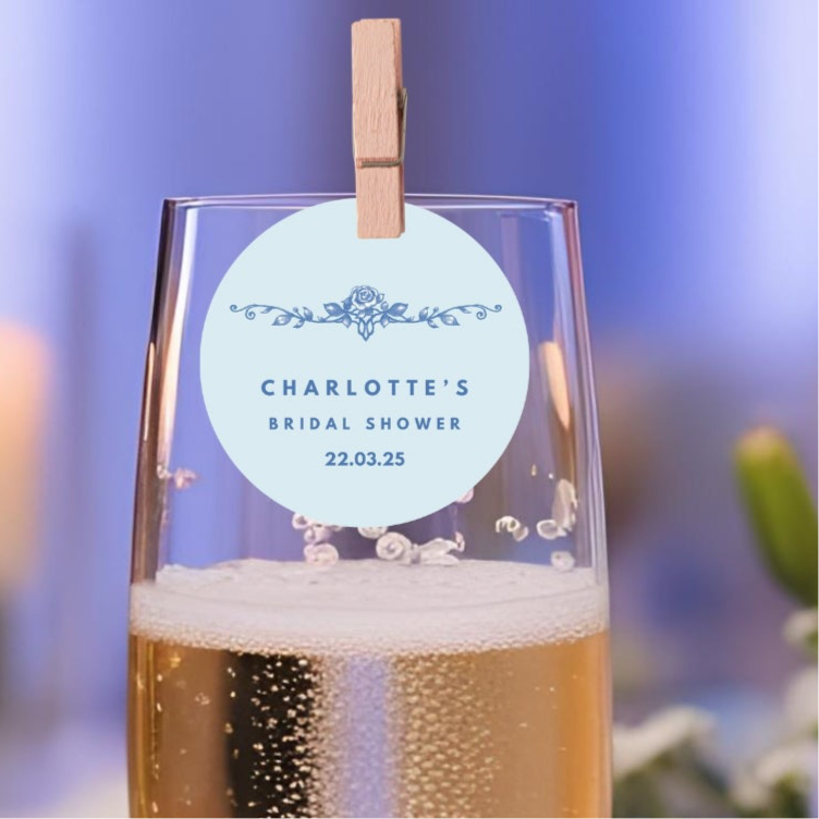 A Little Something Blue Bridal Shower Edible Drink Toppers enhancing a celebratory glass of champagne.