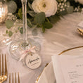 Load image into Gallery viewer, Personalised name wine glass charms with a tag labeled Amanda at a beautifully set table.
