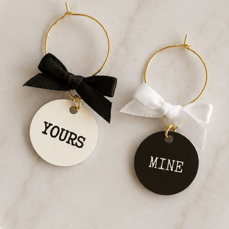 Yours & Mine Drink Glass Wine Charms-Duo featuring black and white charms with bows.