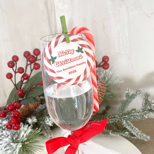 Candy Cane Christmas edible drink toppers decorating a festive glass with a holiday label and candy cane.