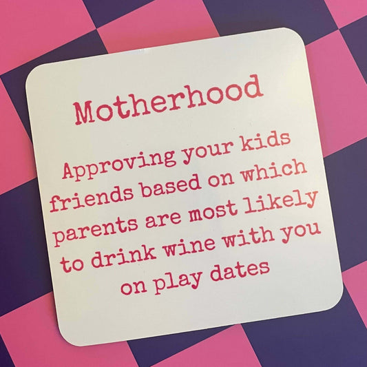 Motherhood and Wine Drink Coaster featuring humorous text about parenting and wine on a colorful background.