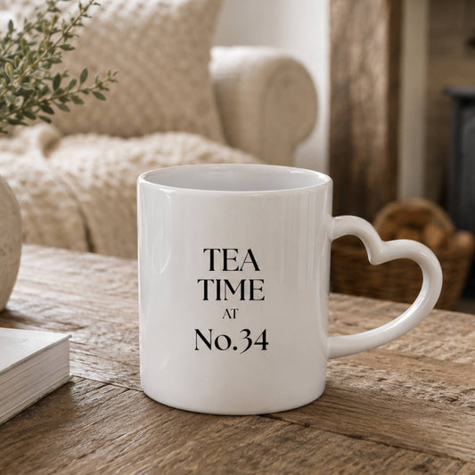 Personalised tea time mug with heart-shaped handle on a wooden table.