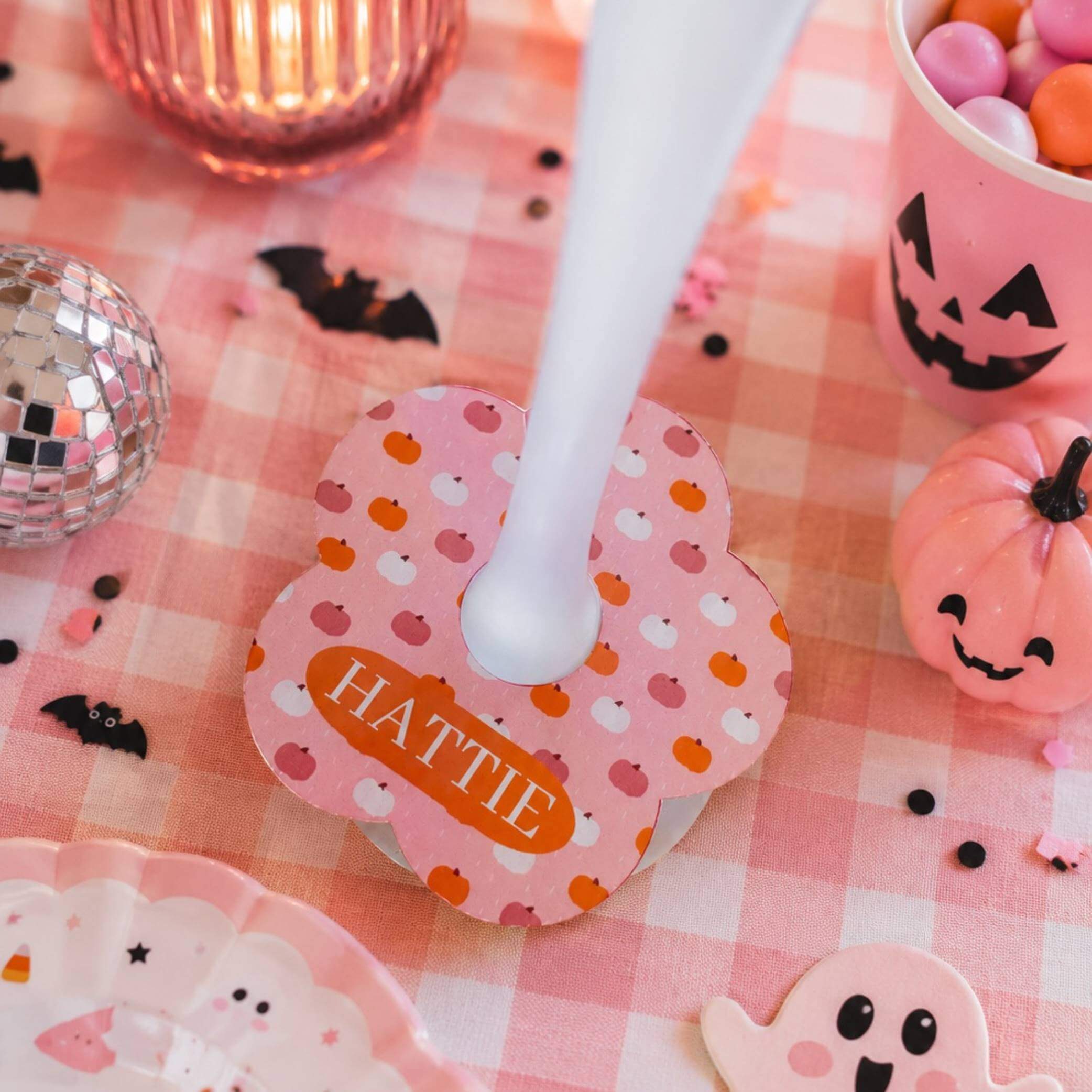 Pretty Pumpkin Personalised Name Drink Identifiers with the name HATTIE on a pink Halloween-themed table.