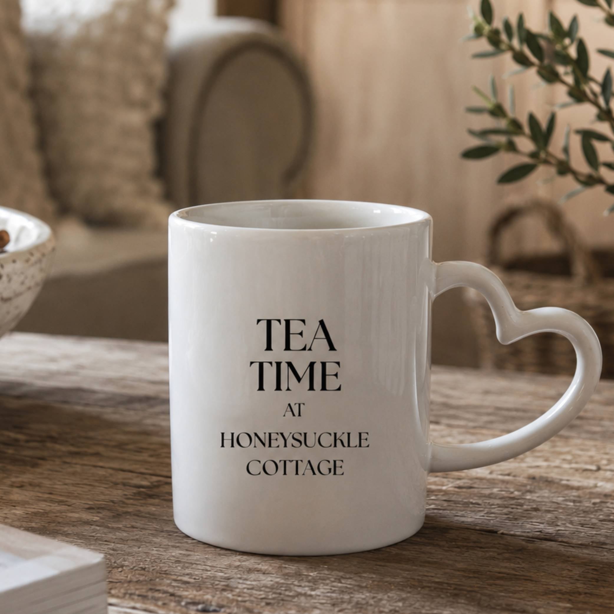 Personalised tea time mug with heart-shaped handle, featuring 'Tea Time at Honeysuckle Cottage' text.