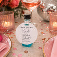Load image into Gallery viewer, She is tying the knot bottle favour tags attached to mini bottle with blue liquid, perfect for hen do celebrations.
