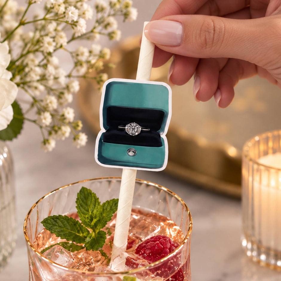 Tiffany blue engagement ring box straw toppers in a drink with a mint leaf and raspberries.