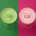 Load image into Gallery viewer, Edible drink toppers featuring Team Elphaba and Team Glinda on cocktails with green and pink backgrounds.
