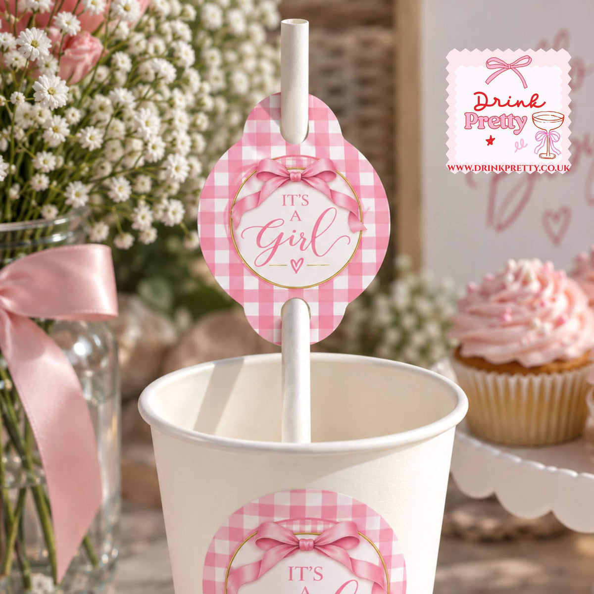 It's A Girl Straw Toppers on a pink gingham design straw in a cup for a baby shower celebration.