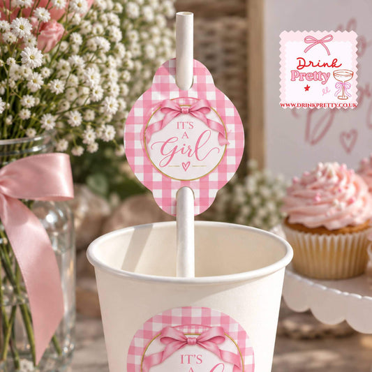 It's A Girl Straw Toppers on a pink gingham design straw in a cup for a baby shower celebration.