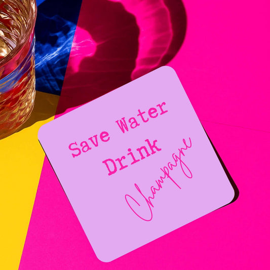Save water drink champagne drink coaster on a colorful background next to a glass of drink.