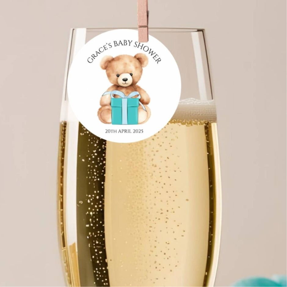 Tiffany Blue Teddy Bear Baby Shower Cocktail Toppers attached to a champagne glass for a baby shower celebration.