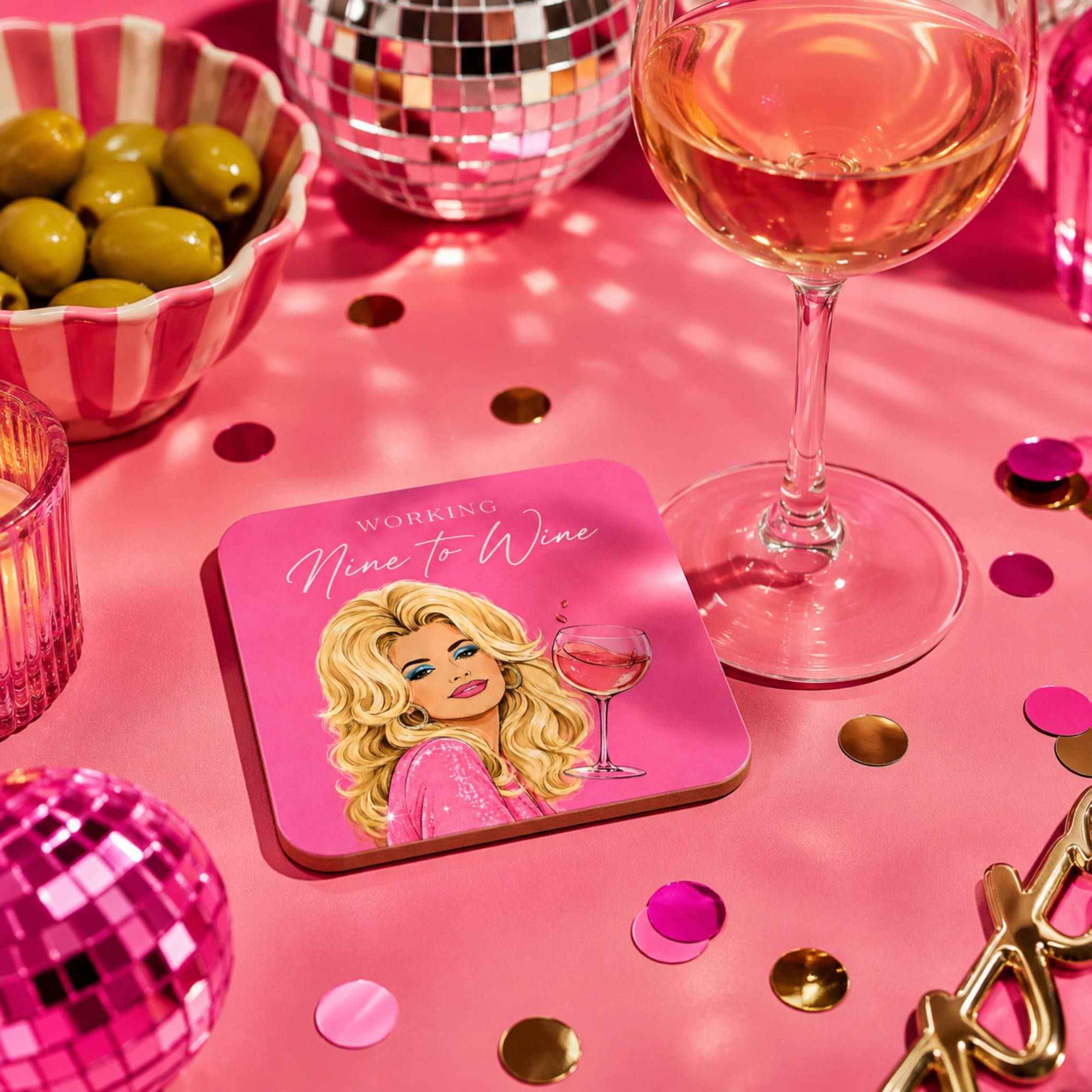 Working Nine To Wine Drink Coaster displayed on a pink table with a cocktail and decorative items.