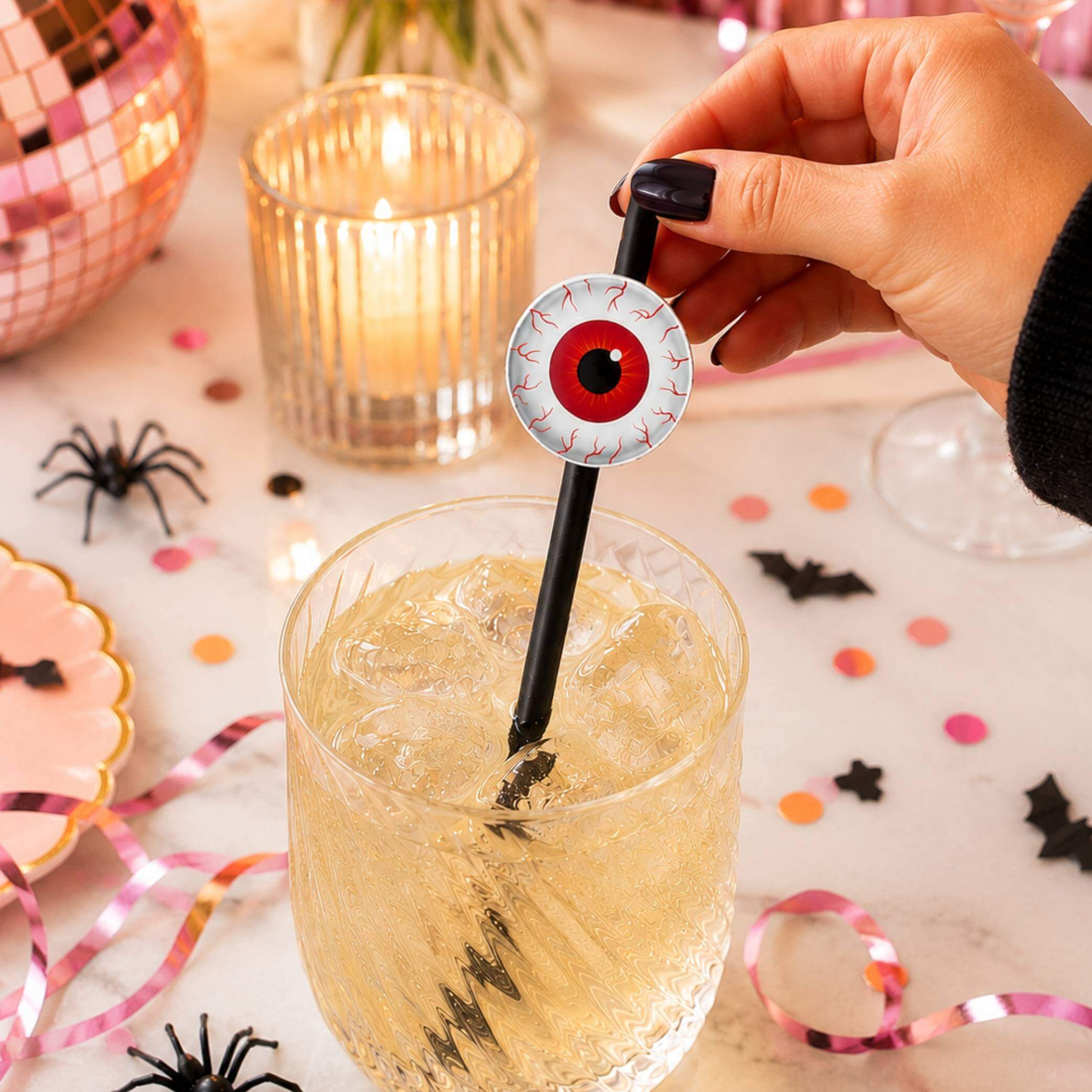 Eyeball Paper Straw Toppers in a Halloween drink, adding a spooky touch to the party with bloodshot eye design.