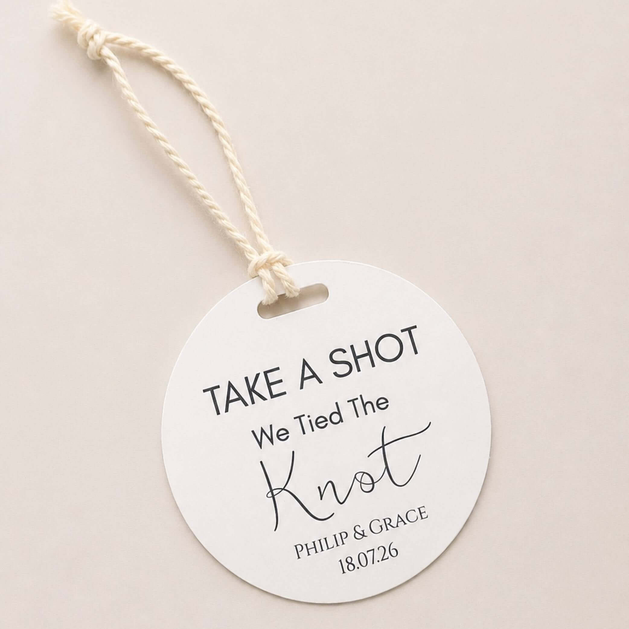 Take A Shot wedding favour bottle tags with We Tied The Knot design and personalized names.