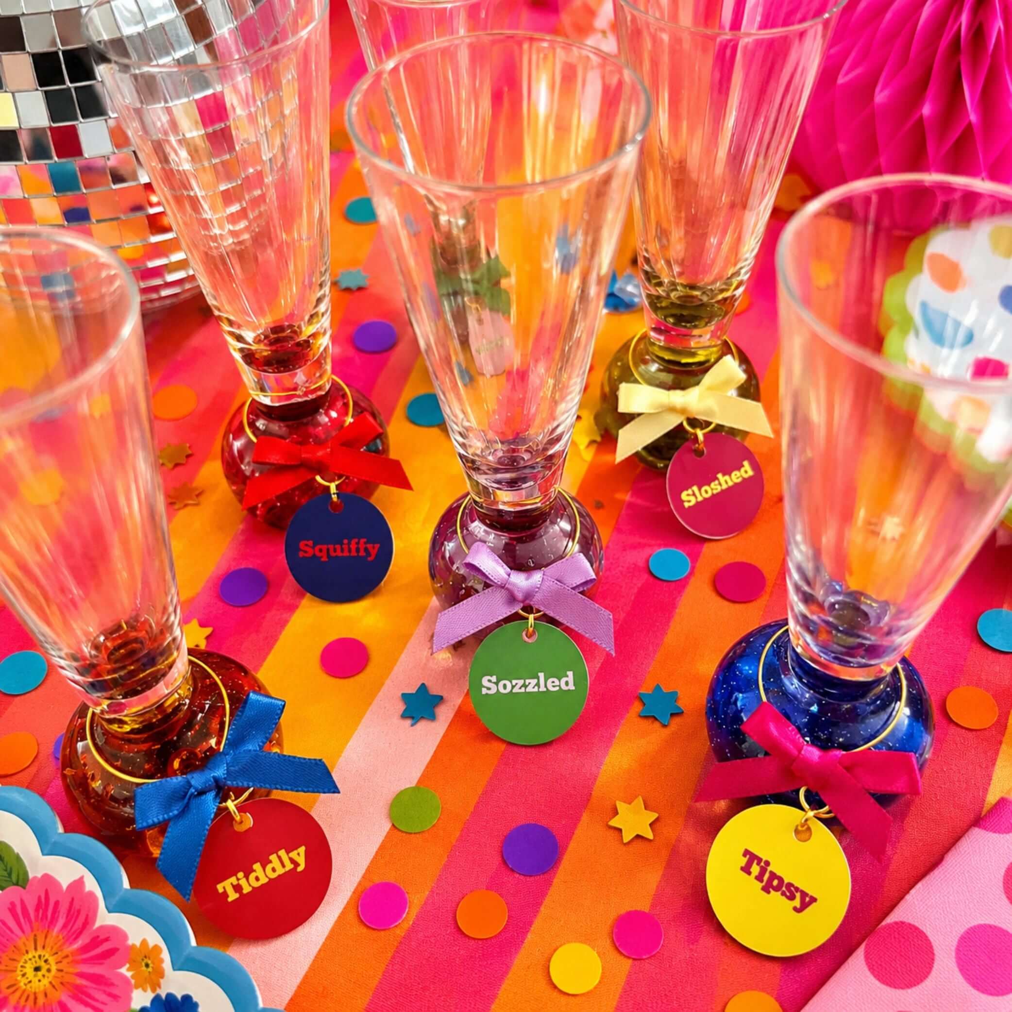 Tipsy Quotes Wine Glass Charm Set Of 6 displayed on colorful table with vibrant charms and glasses